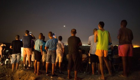 Spectators on the hills above Gaza cheered on the bombing.